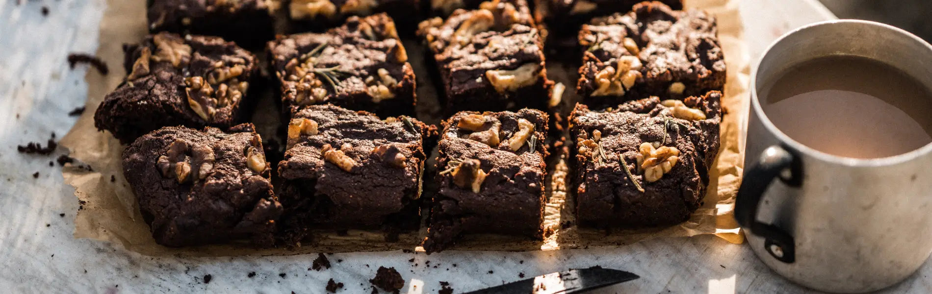 Beetroot brownies on a wooden board next to mug of tea