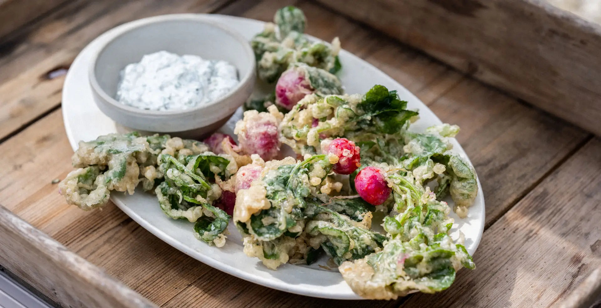 Fried Radishes on a white plate ontop of a wooden tray