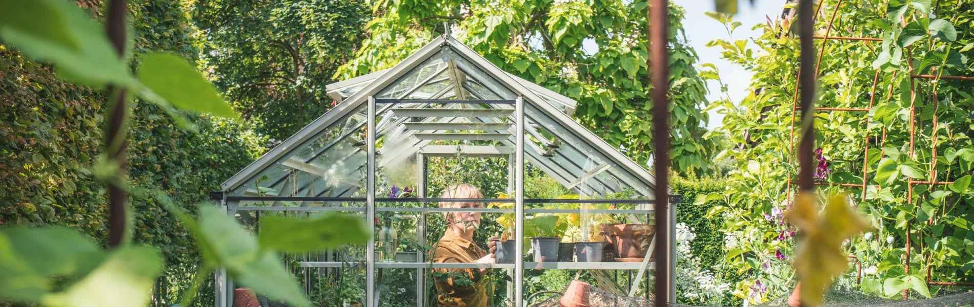 A Rhino greenhouse in a beautifully green garden