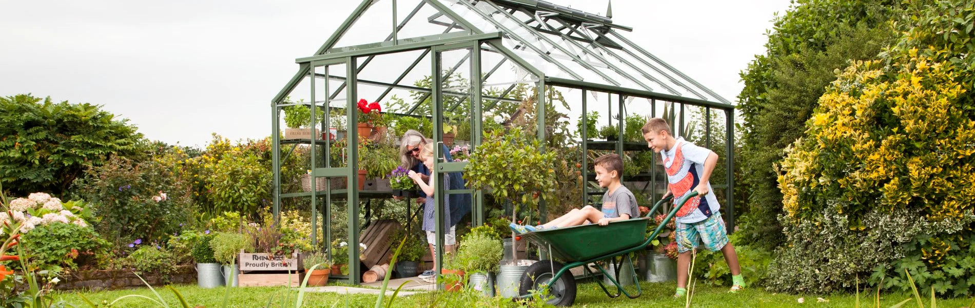 Child in a wheelbarrow being pushed by another